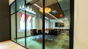 Aluminum glass wall frames with matte black powder coating finish.