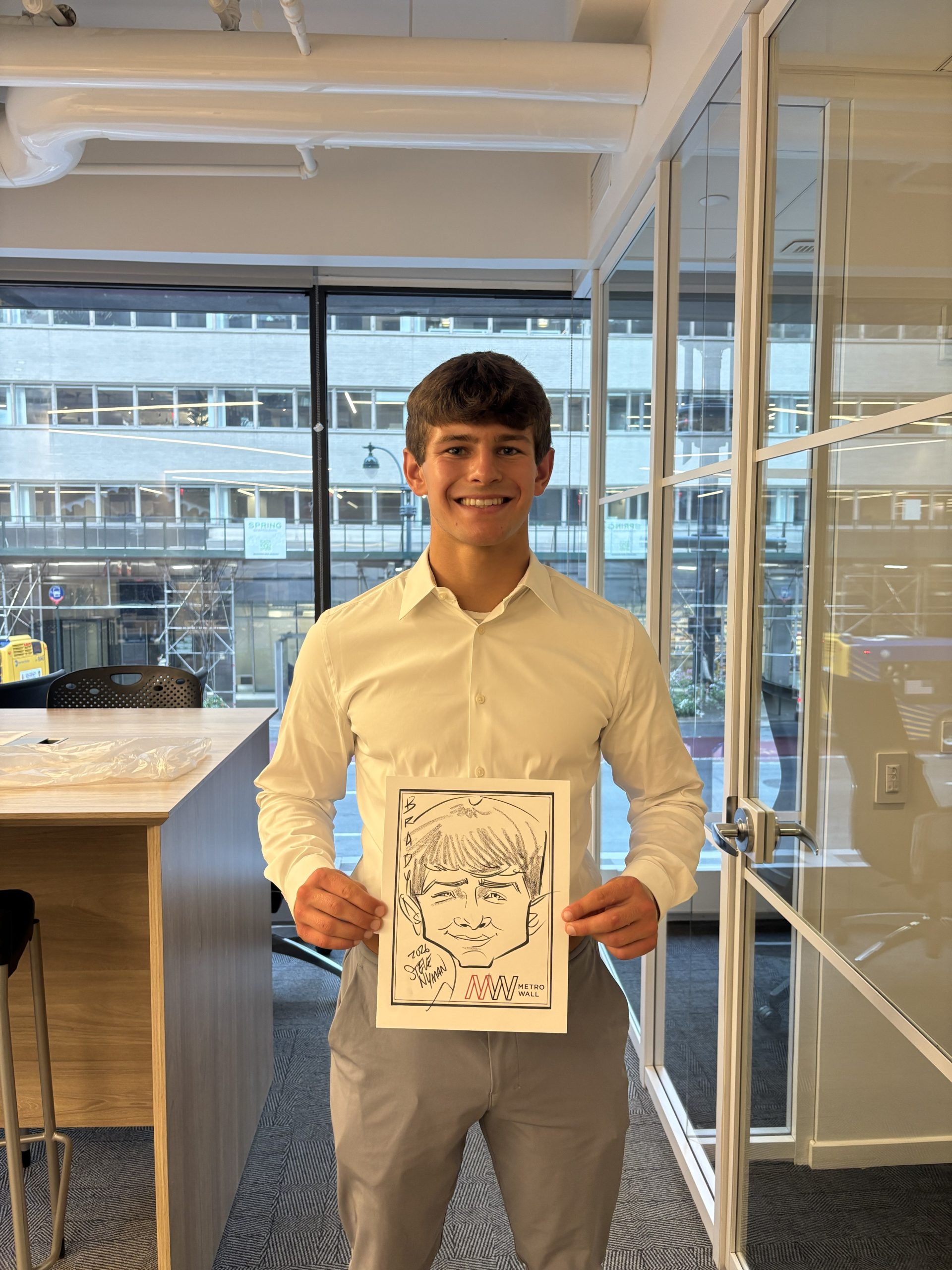 Young-man-smiling-with-caricature-drawing